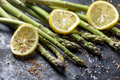 Fresh asparagus dish with lemon and spices on black plate  - PhotoDune Item for Sale