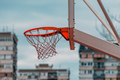 Street hoops, outdoor basketball court rim and the net with apartment building in background - PhotoDune Item for Sale
