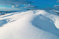 Aerial shot of snow-capped hill top lit by the setting sun in winter sunset at Zlatibor - PhotoDune Item for Sale