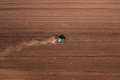 Agricultural tractor with tiller attached performing field tillage before the sowing season - PhotoDune Item for Sale
