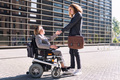 man and woman using wheelchair shaking hands - PhotoDune Item for Sale