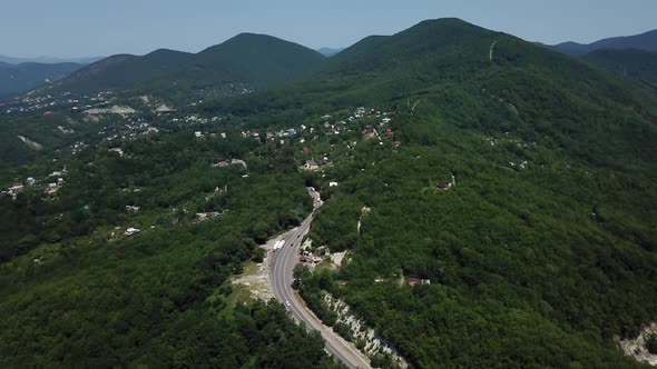 Aerial View From Above of Curve Road with a Car on the Mountain with Green Forest in Russia