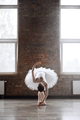 Classical ballet dancer doing roll down at end of her performance - PhotoDune Item for Sale