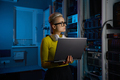 Portrait of concentrated woman coder solving problem in data center - PhotoDune Item for Sale