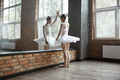 Worried ballerina standing near huge mirror at dance studio - PhotoDune Item for Sale