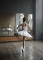 Beautiful young ballerina training classic ballet in studio with huge mirror - PhotoDune Item for Sale