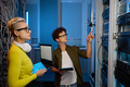 Serious technicians working together with network hardware - PhotoDune Item for Sale