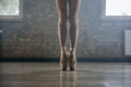 Elegant female ballerina legs in pointe shoes standing on toes at ballet class - PhotoDune Item for Sale