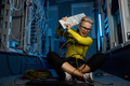 Frustrated angry female IT technician throwing computer keyboard in server room - PhotoDune Item for Sale
