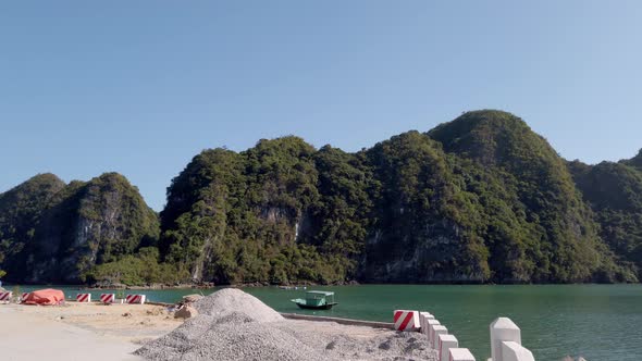 Men riding bicycles on a road along Viet Hai Harbor in Cat Ba Vietnam, Follow behind shot