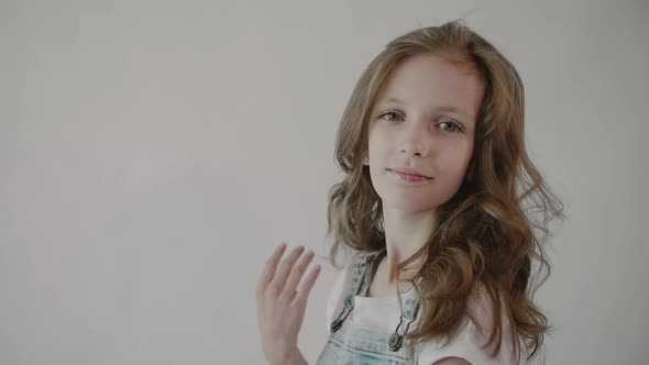 Girl straightens her hair. Portrait of a young girl touching her hair. Hairstyle	