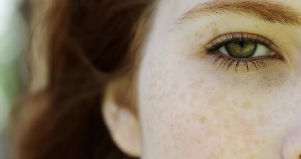 Close-up of eyes of beautiful woman with freckles