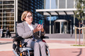 businesswoman using wheelchair using mobile phone - PhotoDune Item for Sale