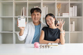 Asian young couple use calculator calculate expenses finance and discuss plan together at home - PhotoDune Item for Sale