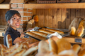 Female Baker Holding Tray With Baguette - PhotoDune Item for Sale