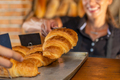 Bakery Shop. Female Baker Selling Croissant - PhotoDune Item for Sale