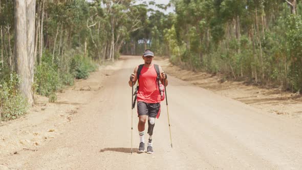 Sporty mixed race man with prosthetic leg hiking