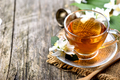 Herbal green tea border on wooden rustic background. Hot cup of jasmine tea on vintage  table - PhotoDune Item for Sale