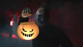 Masked man shows halloween pumpkin - PhotoDune Item for Sale