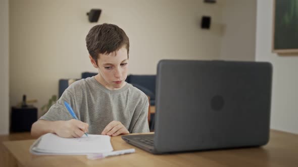 Young boy attending an online lesson during the COVID-19 lockdown