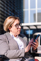businesswoman using wheelchair typing on mobile - PhotoDune Item for Sale