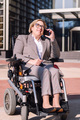 businesswoman using wheelchair talking by phone - PhotoDune Item for Sale