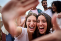 Capturing moments. Portrait of two Caucasian beautiful girls making photo frame with hands at party. - PhotoDune Item for Sale