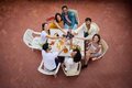 Portrait from above young multiracial friends toasting glasses red wine celebrating rooftop party. - PhotoDune Item for Sale