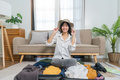 Young asian woman traveler pack stuff in suitcase prepare for holiday vacation at home. backpacker - PhotoDune Item for Sale