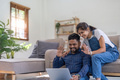 Happy couple indian waving hand while using a laptop to make a video call with family from home - PhotoDune Item for Sale
