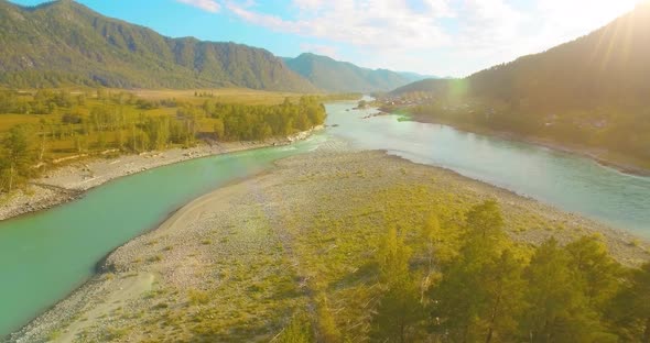 Low Altitude Flight Over Fresh Fast Mountain River with Rocks at Sunny Summer Morning.