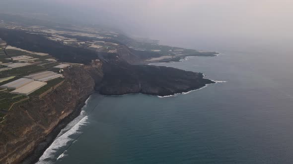 Solidified lava flow in sea after volcano eruption at La Palma, Canary islands. Aerial forward
