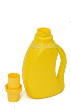 Yellow plastic bottle with a dispenser in cap, isolated on white background