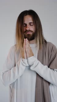 Jesus Prays with His Hands Together on a White Background alt