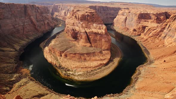 Zoom Out Shot of Horseshoe Bend, Motor Boat Moves Along Colorado River