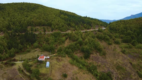 steep green mountains, deep forest and mountain road, beautiful valley and village houses