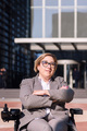 businesswoman using wheelchair with arms crossed - PhotoDune Item for Sale