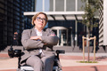 businesswoman using wheelchair with arms crossed - PhotoDune Item for Sale