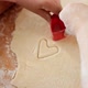 Closeup of Little Boy Cutting Out Heart Shapes on Dough for Biscuits - VideoHive Item for Sale
