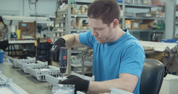 Worker testing LED lamp in an advanced electronics manufacturing facility