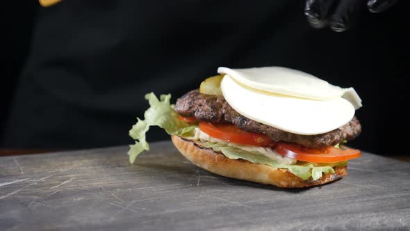 SLOW MOTION FOOD Concept. Chef Making Burger. Close-up . Burger Restaurant Menu Cooking Process