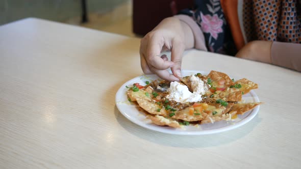 Women Eating Corn Chips Nachos with Fried Minced Meat