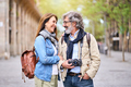 Loving elderly tourist couple looking at romantic outdoors in city. Smiling adult people traveling. - PhotoDune Item for Sale