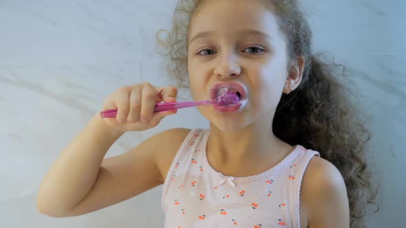 Happy Portrait Cute Caucasian Young Little Girl Brushing Teeth in Bathroom. Child Daily Healthcare