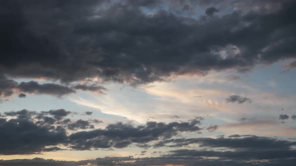 Moving gray pink clouds across the sky, time lapse