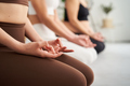 Close up of unrecognizable woman hands practicing yoga mudra earth exercises in class. Copy space. - PhotoDune Item for Sale