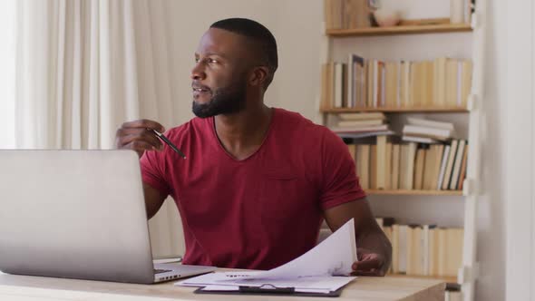 Thoughtful african american man reading documents