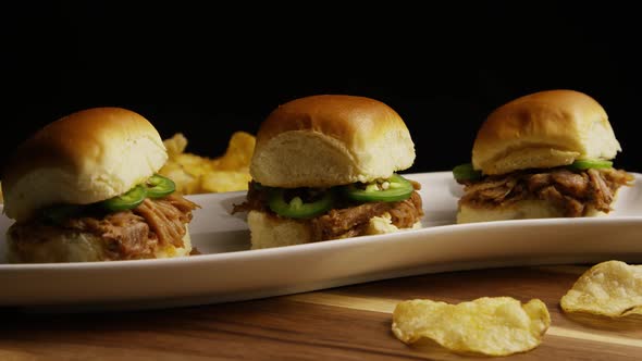 Rotating shot of delicious pulled pork sliders 