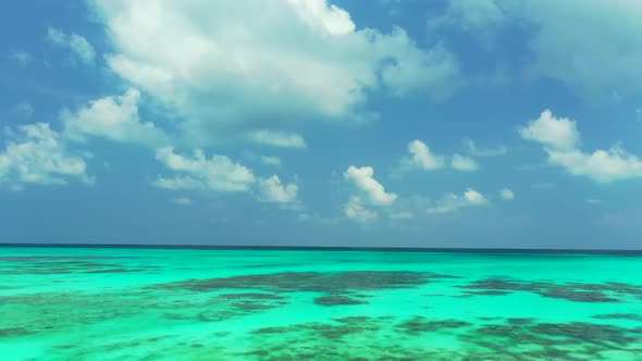 Aerial drone shot scenery of paradise seashore beach lifestyle by blue sea with white sandy backgrou