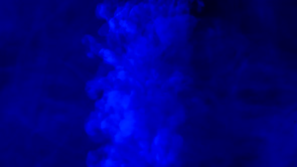 A smokey blue ink drop cloud collision for a dark abstract background SLOW MOTION.